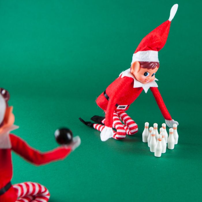Two Elves Behavin Badly toy elves playing with a mini bowling set