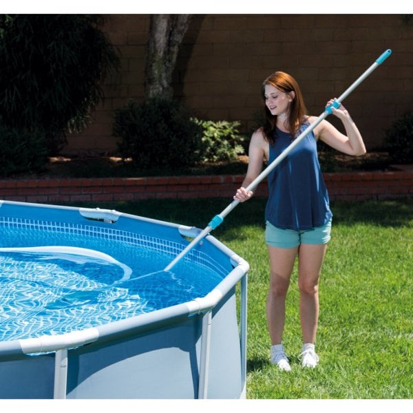 Women cleaning an above-ground pool